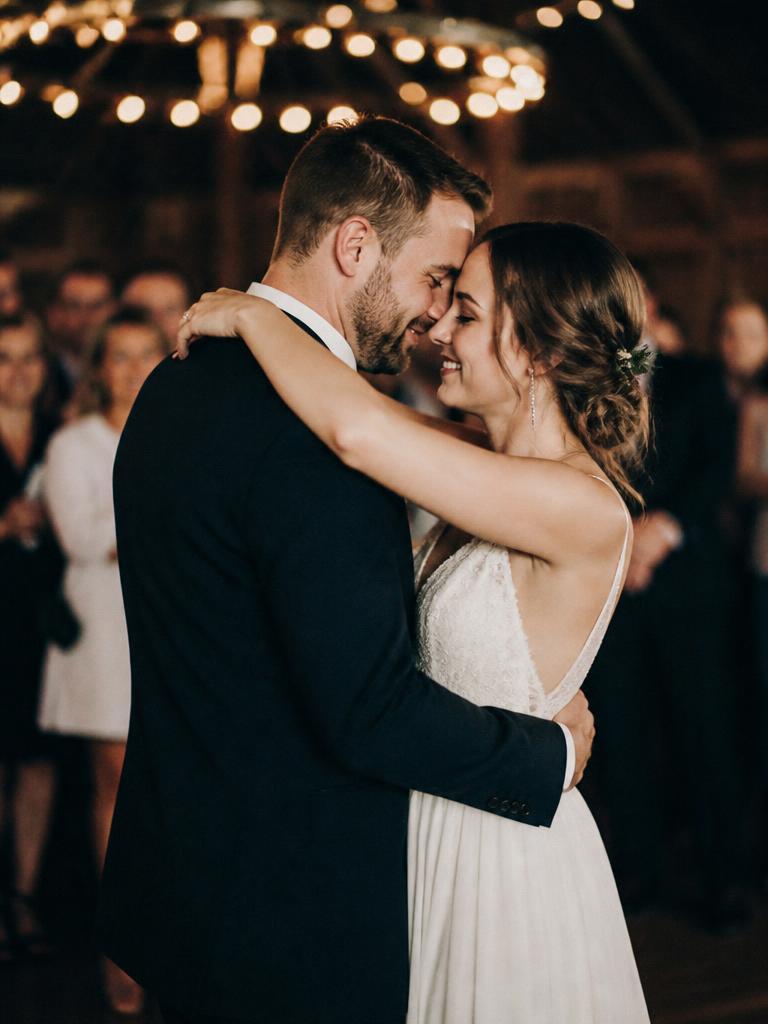 Laura and Marc dancing under festoon lights at their wedding